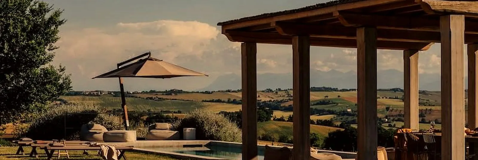 Pergola and pool with countryside views at a luxury villa in Le Marche, Italy